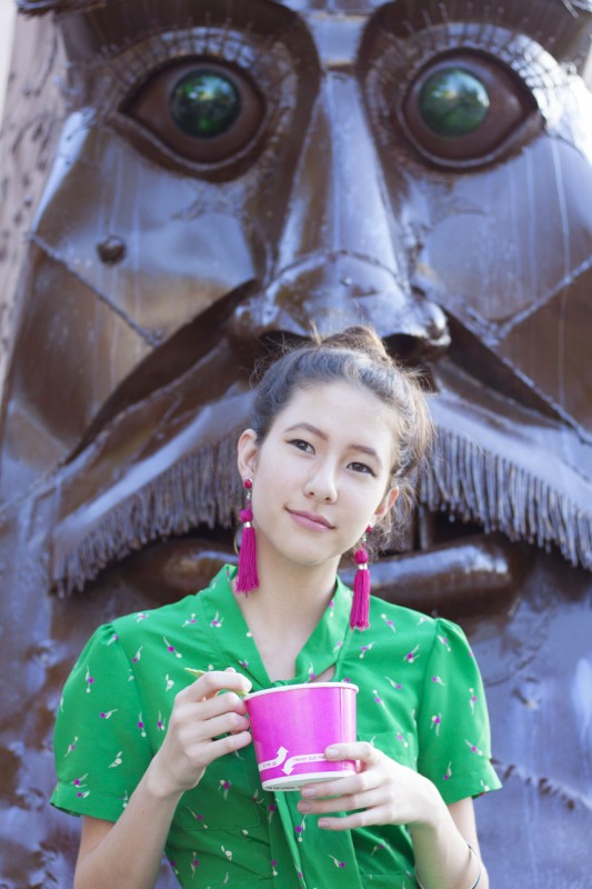 Enjoying the sun, Mizusawa is enjoying a cup of frozen yogurt by Mochi while wearing Forever 21's green print cap sleeved dress with the bow and magenta fringe earrings. Photo courtesy of Ronan Galvez.
